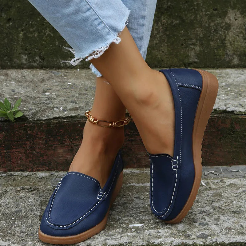 Women's flat loafers in PU leather with car stitch detail and round toe, shown in multiple colours.
