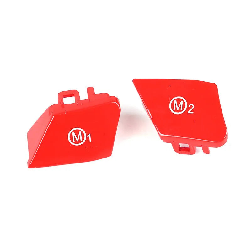 Pair of red and blue BMW M1 M2 steering wheel mode buttons with installation keys on a plain background.