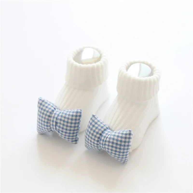 Cotton baby floor socks in various patterns including animal prints, stars, and bows for infants aged 0-3 months