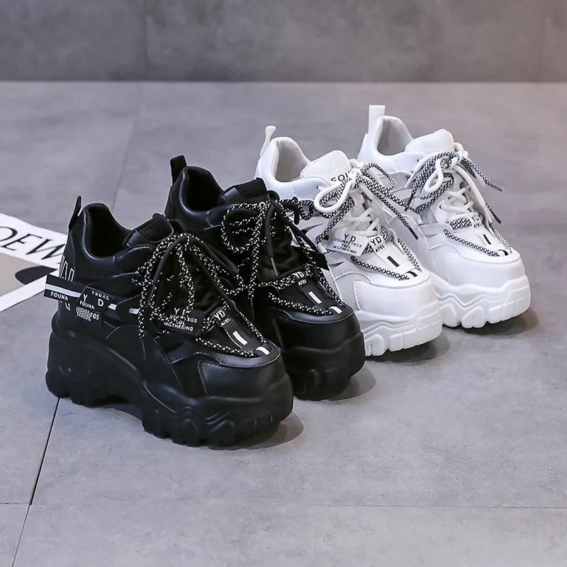 Women's white and black mesh platform sports shoes with cross-strap detail and rubber soles