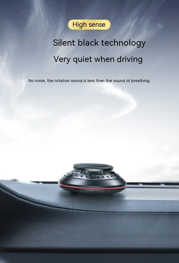 Solar-powered aluminium alloy car air freshener diffuser in black colour on a car dashboard.