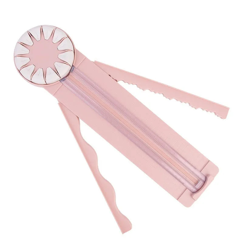 Pink 12-in-1 dotted line paper cutting machine on desktop for card making and scrapbooking