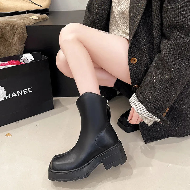 Black women's platform Martin boots with a square toe, high heel, and back zip.