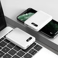 Black or white portable power bank with dual USB ports showing 10000mAh capacity label