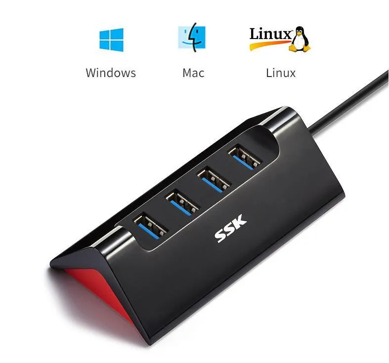 Black USB expansion dock with four ports on a desktop next to a laptop.