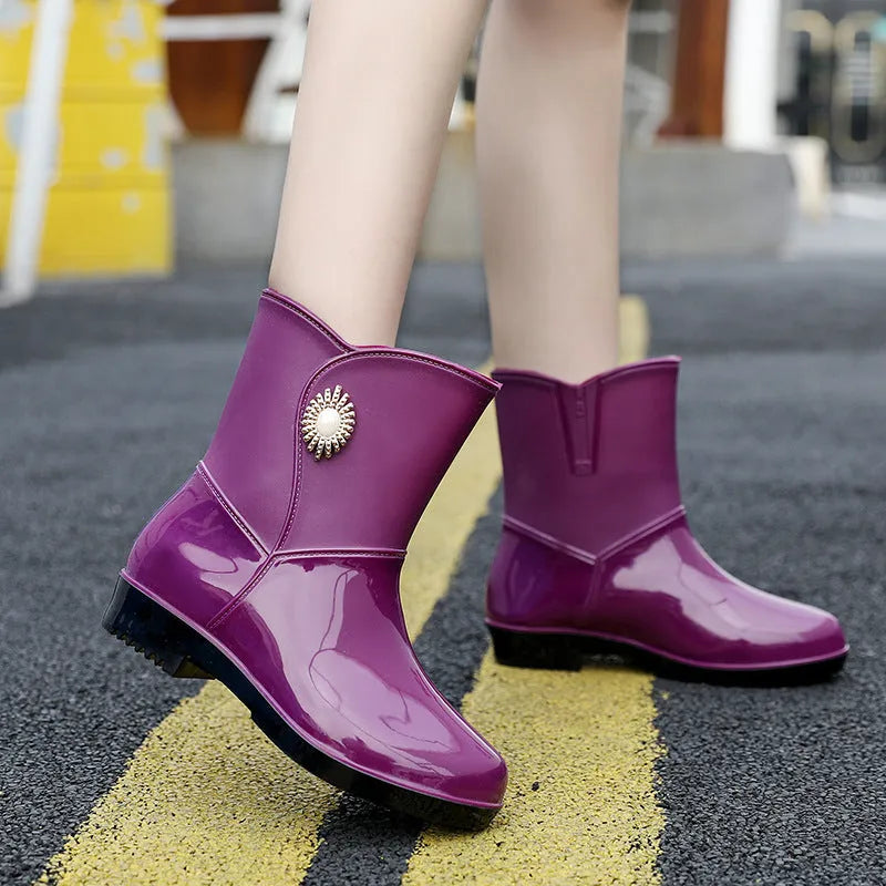 Women's mid-calf rain boot in purple PVC with a non-slip sole and low tube design.