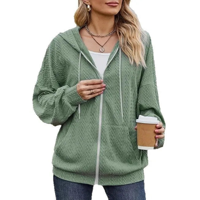 Green women's loose-fit hooded zip-up jacket on a hanger