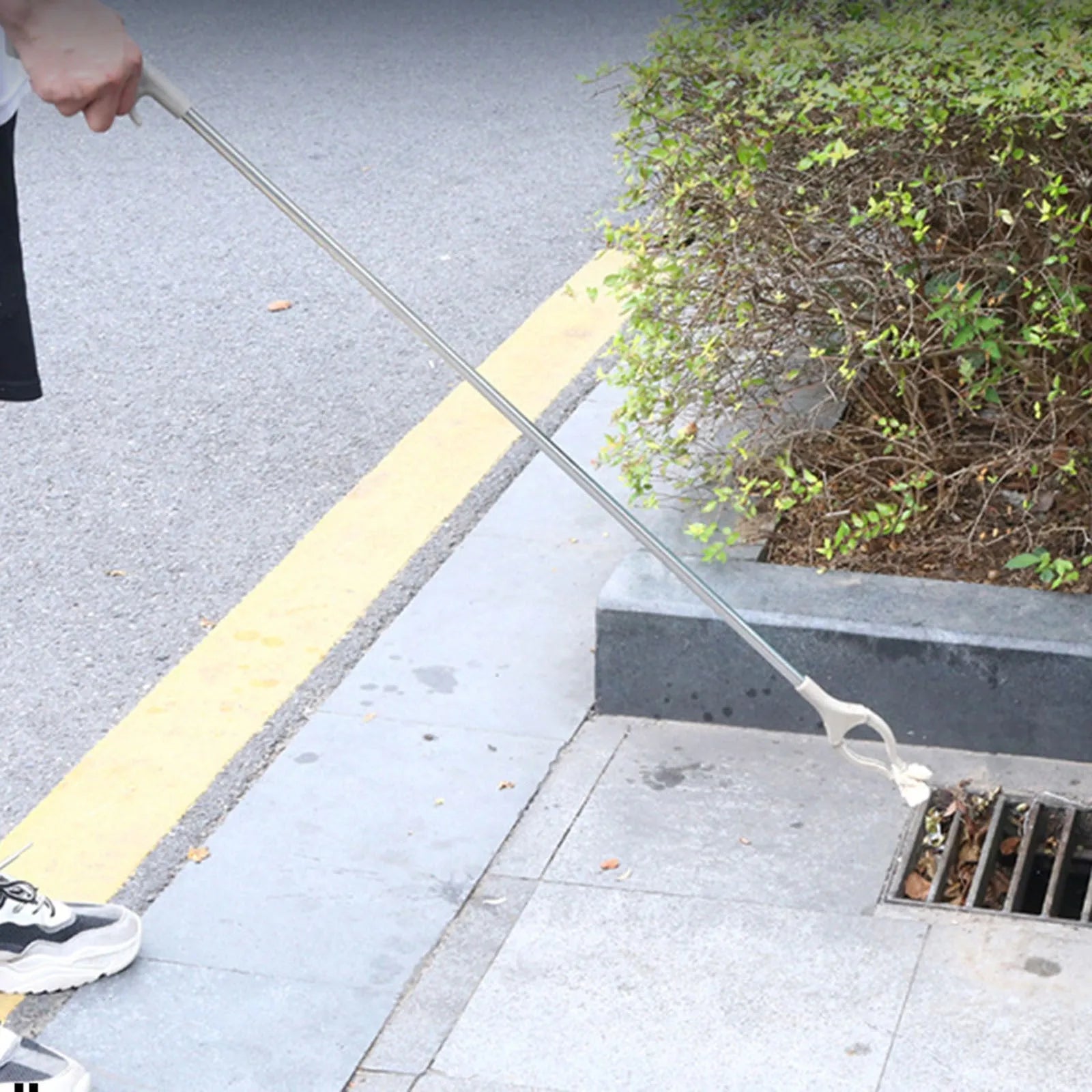 Stainless steel garbage picker pliers with extended 40cm reach and push-type handle for one-handed operation