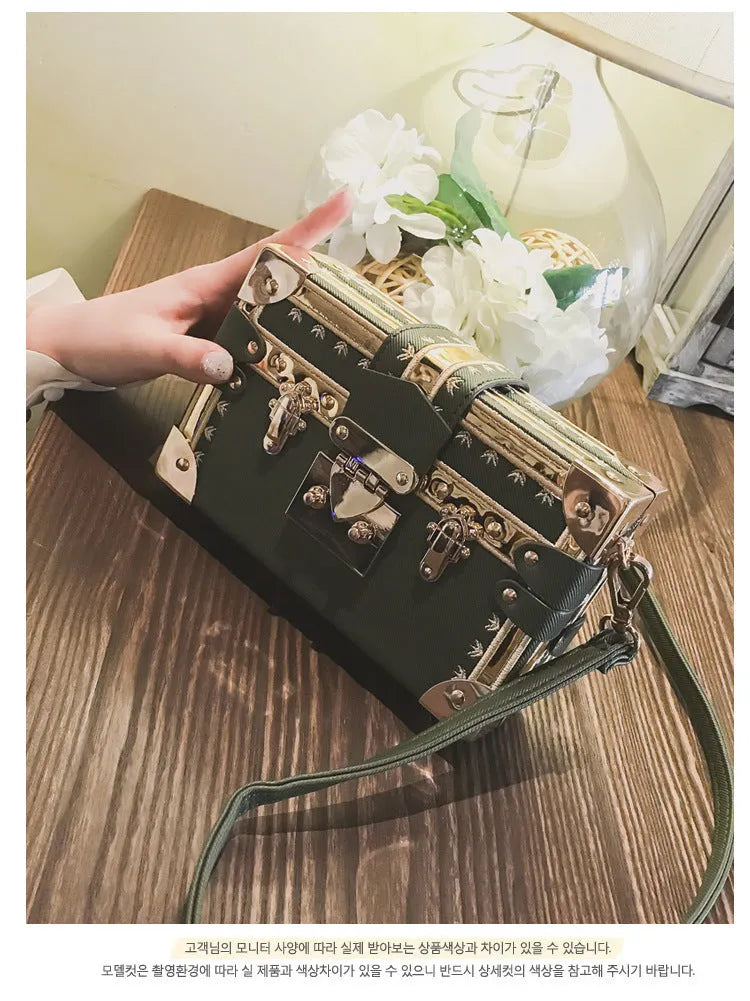 Hard black PU women's shoulder bag with flap closure and single adjustable cross-body strap.