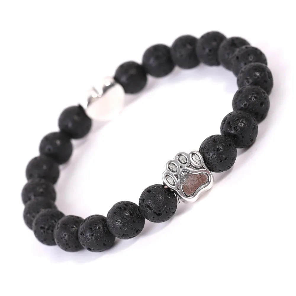 A round beaded stone bracelet in a Tiger Eye or Indian Agate style on a wrist.
