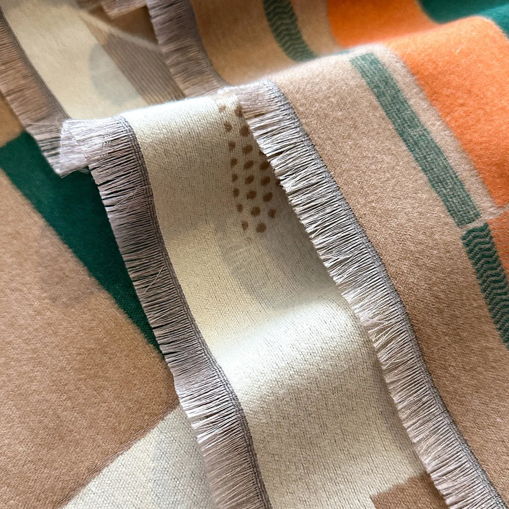 Long beige imitation cashmere scarf draped to show its 185cm length and texture.