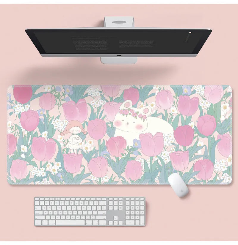 Large flower pattern mouse pad on a desk with keyboard, showing non-slip rubber base and colourful tulip design.