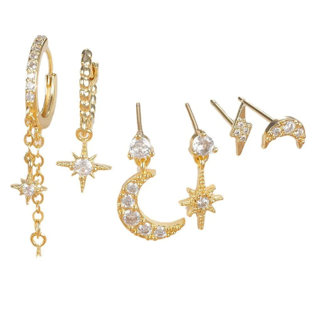 Six pairs of gold electroplated chain tassel earrings with zircon studs on display