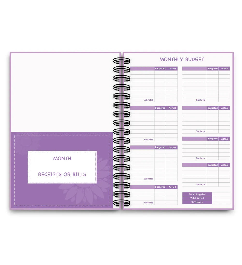 Purple coil-bound budget book open showing monthly financial planning layout with stickers and paper clips