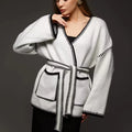 Loose fit knitted cardigan sweater coat in camel colour, showing long sleeves and mid-length hem.