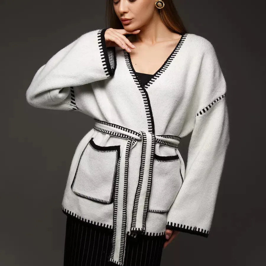 Loose fit knitted cardigan sweater coat in camel colour, showing long sleeves and mid-length hem.