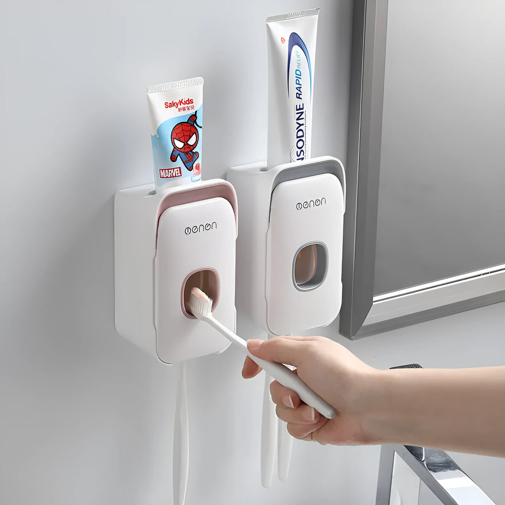 Automatic wall-mounted toothpaste dispenser in blue, grey, and pink colours with USB charging cable.
