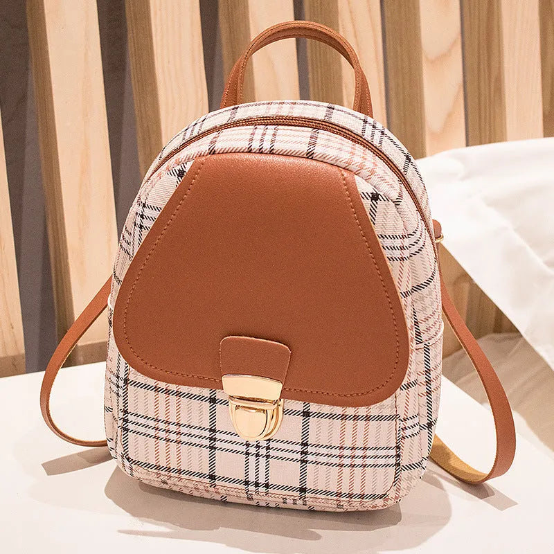 Diagonal shoulder phone bag in PU material showing adjustable strap and handheld carry option