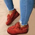 Women's white cotton slippers with a fleece lining, round toe, and grey non-slip rubber sole.