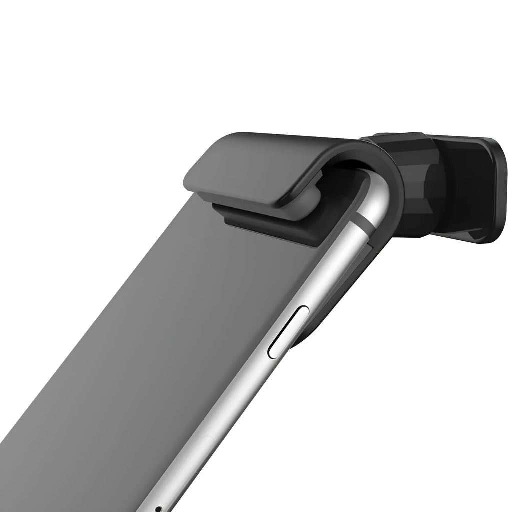 Black universal gravity car phone holder with 360-degree rotating head on a car dashboard.