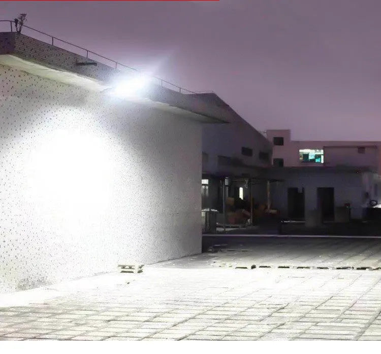 Black solar-powered outdoor street light with motion sensor for garden and driveway illumination