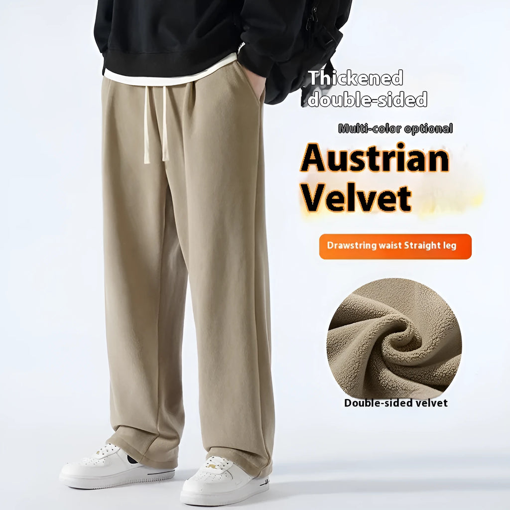 Men's thick apricot coloured fleece-lined loose fit casual sports trousers on a hanger.