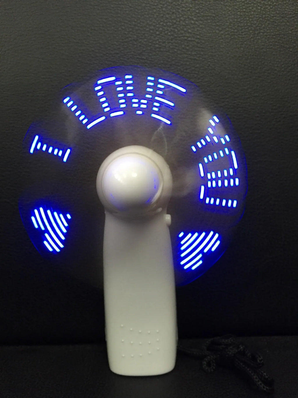 White handheld mini fan with LED lights displaying love pattern and I love you message