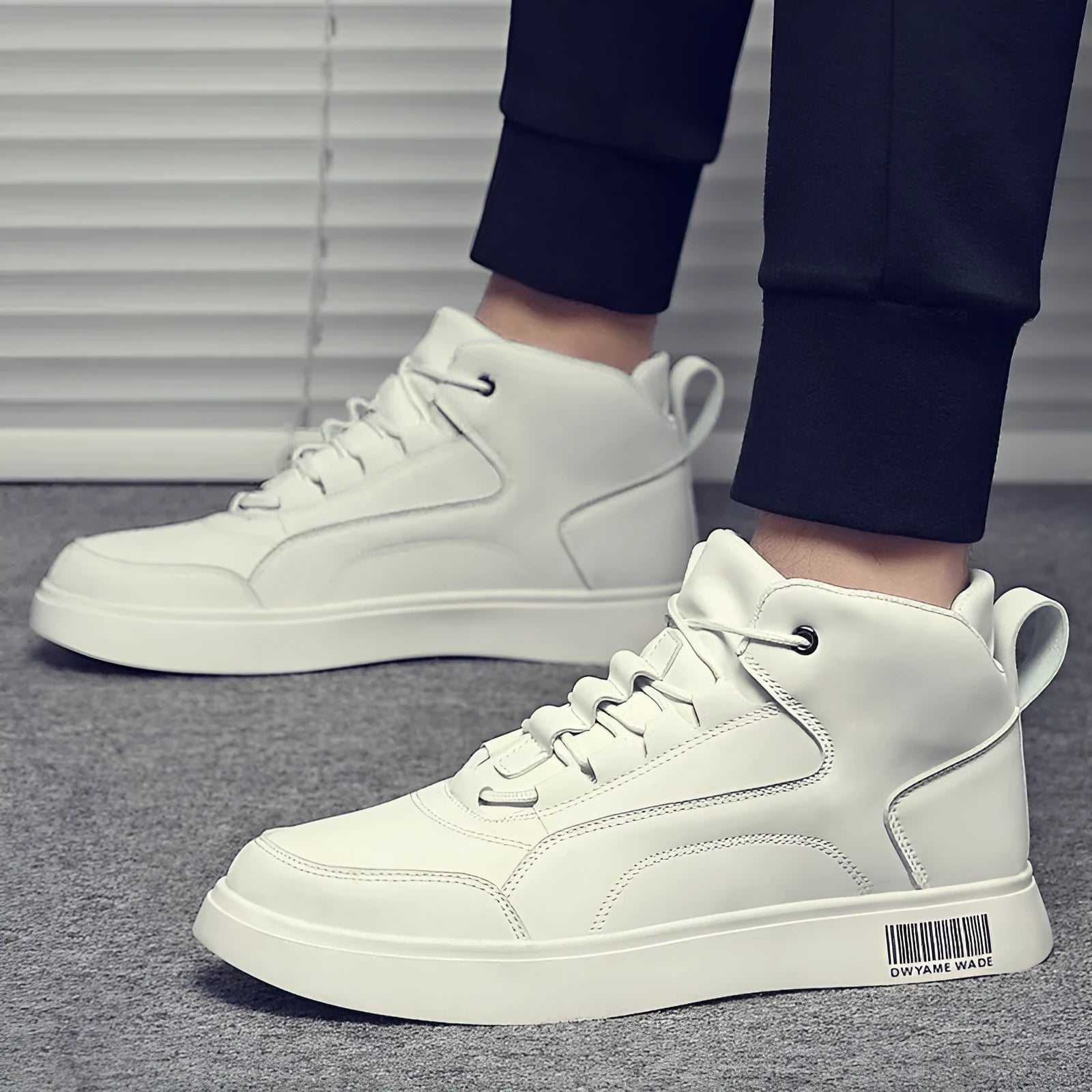 Men's white mid-top lace-up casual shoes with a round toe and rubber sole on a neutral background.
