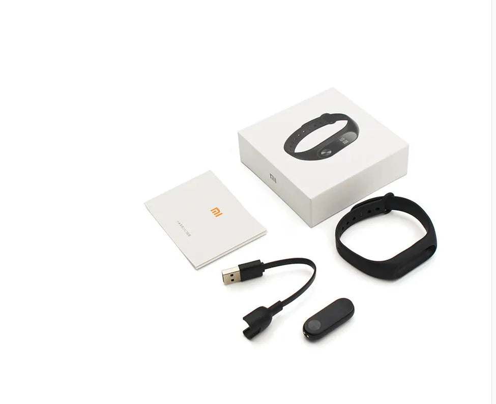Xiaomi Mi Band 2 black fitness tracker with OLED screen on a grey wrist strap.