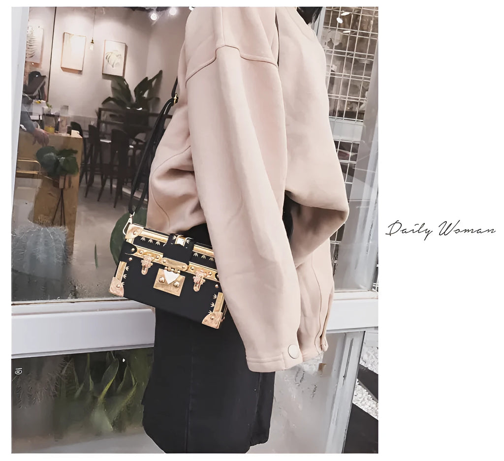 Hard black PU women's shoulder bag with flap closure and single adjustable cross-body strap.