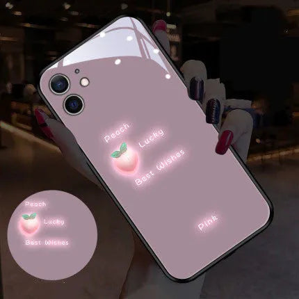 White daisy design voice-activated luminous TPU case for Apple iPhone on a table.