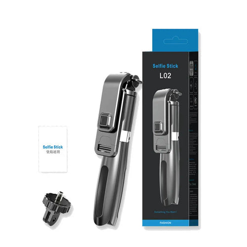 Black and white Bluetooth selfie stick with wireless remote, extended on a tripod base next to a smartphone.