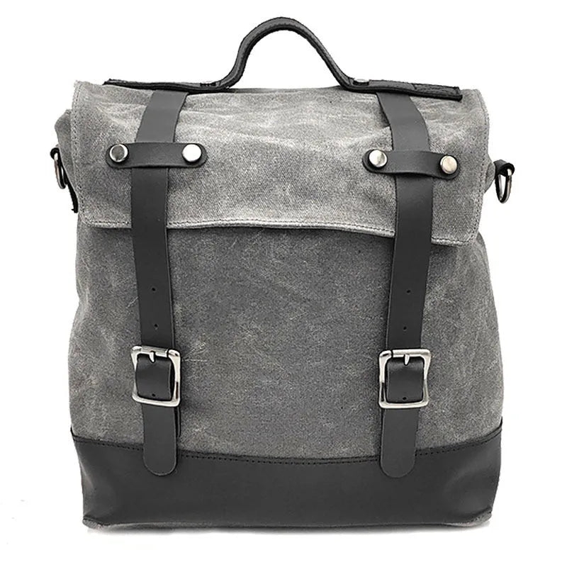 Black waterproof canvas motorcycle side pannier bag with leather trim mounted on a bike