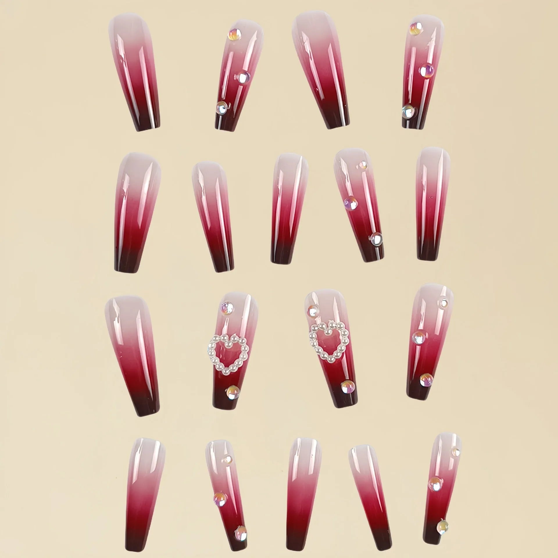 Wine red gradient fake nail tips with pearl heart design in a long ballet style.