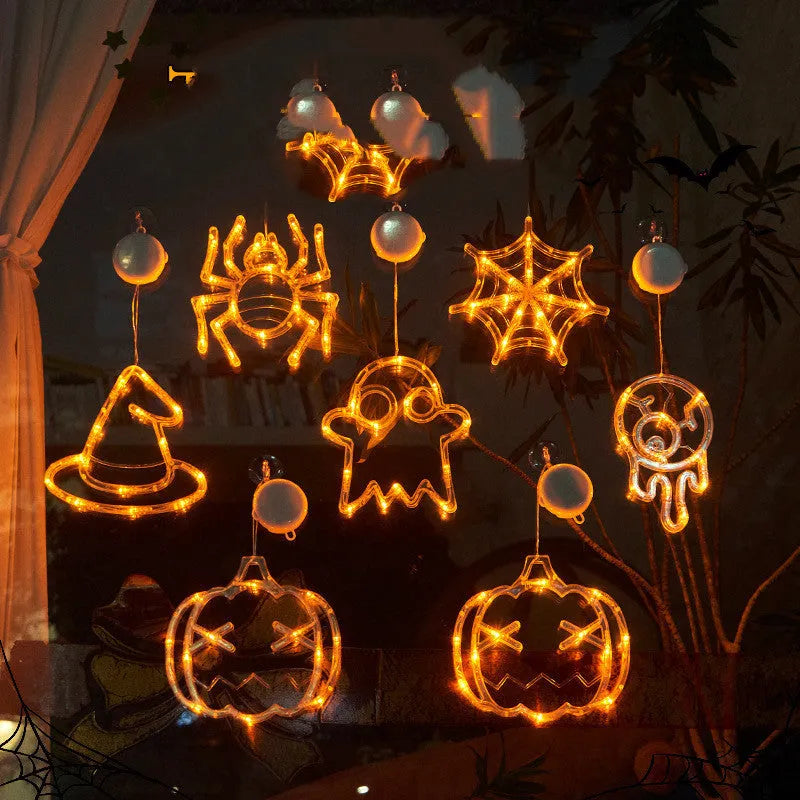 Set of seven battery-powered Halloween LED hanging lights with ghost, spider, and pumpkin designs for window decoration.