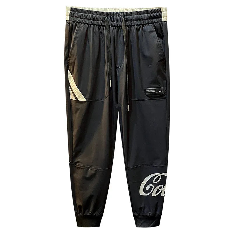 Men's black cropped trousers with ankle banding in ultra-thin ice silk fabric laid flat to show casual design.