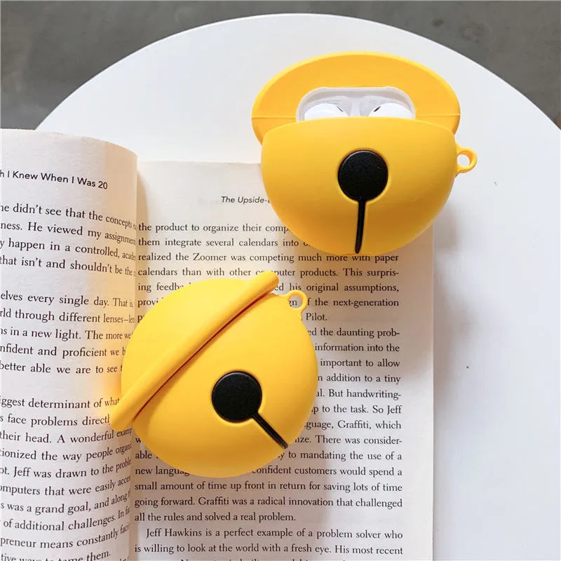 Yellow silicone AirPods case with small bell accessory attached for AirPods 1 and 2