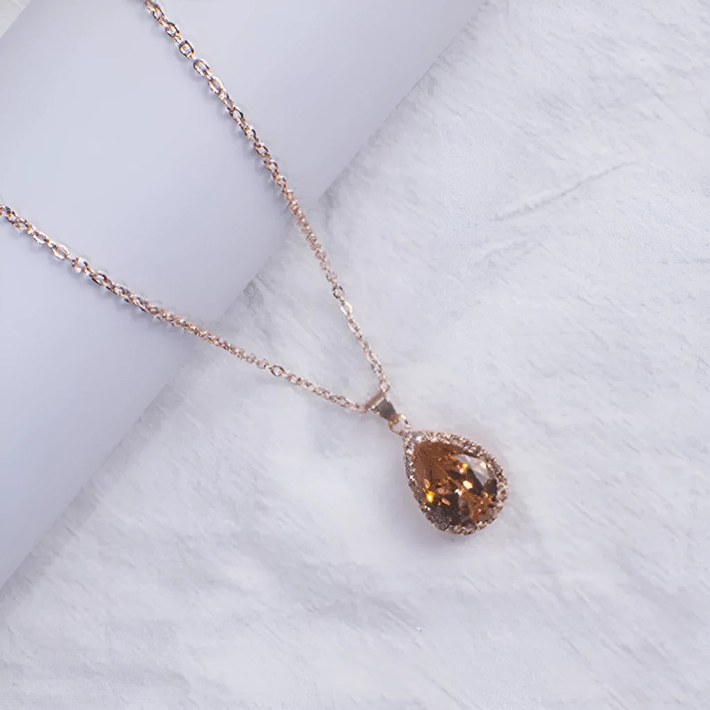 Drop shape geometric pendant necklace with rhinestone inlay in pink rose gold electroplated finish