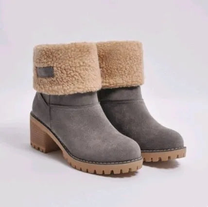 Women's black suede mid-tube knight snow boots with a thick sole and low flat heel on a plain background.