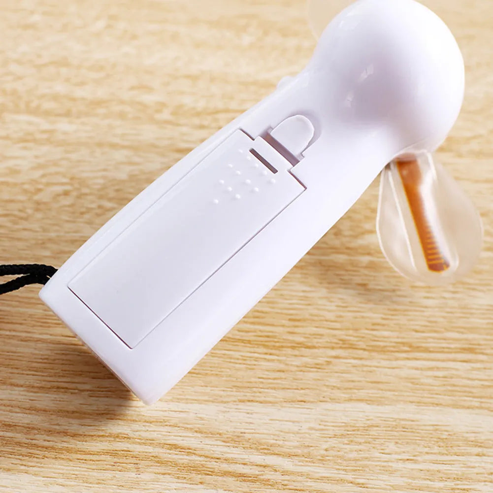 White handheld mini fan with LED lights displaying love pattern and I love you message