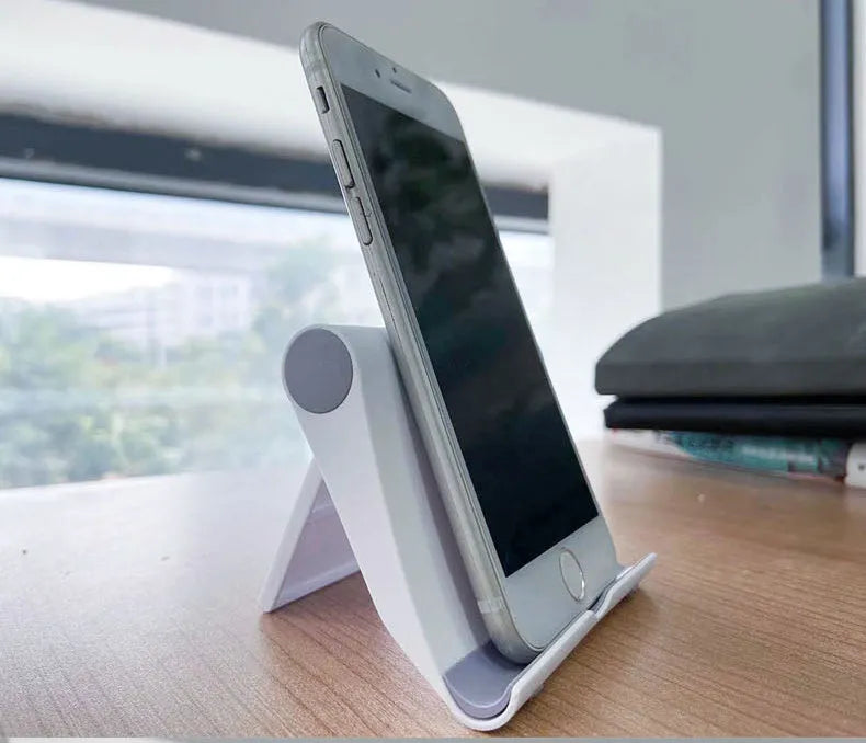 PE folding mobile phone stand in multiple colours showing multi-angle adjustment for tablets and smartphones