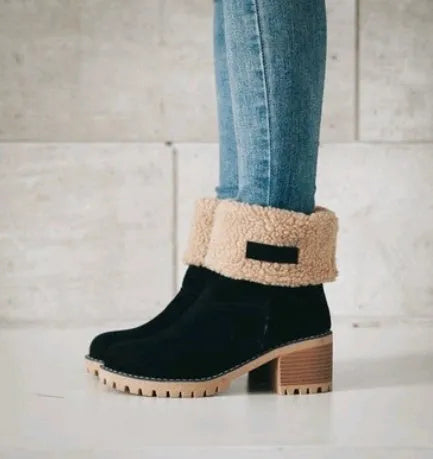 Women's black suede mid-tube knight snow boots with a thick sole and low flat heel on a plain background.