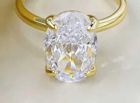 Oval 9 silver women's ring with four-claw setting holding a hand-cut gemstone.