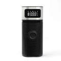 Black portable wireless smart vehicle air pump with USB-C cable and multiple nozzles on a grey background.