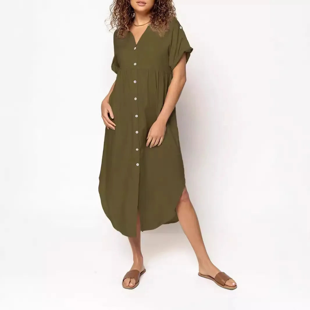 A loose-fitting, solid colour mid-length casual dress with a button-down front and regular sleeves.