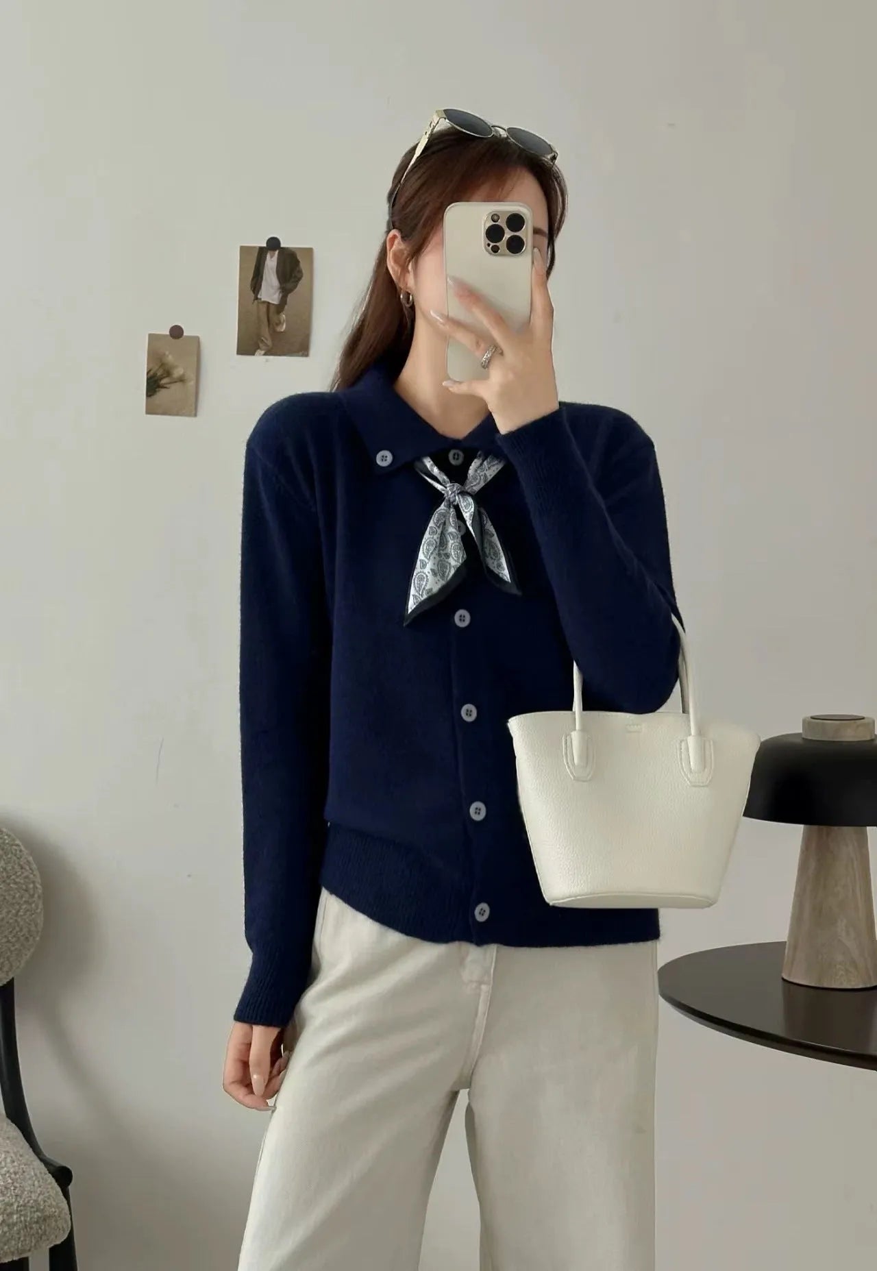Beige cardigan sweater with attached lapel scarf and long sleeves on a model.