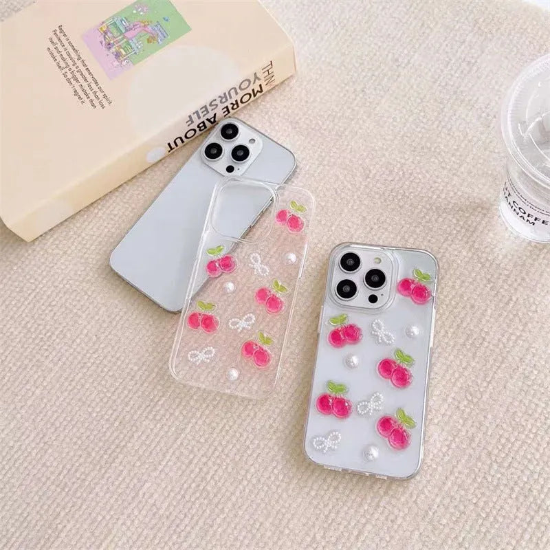 Epoxy three-dimensional cherry bow phone case in transparent finish showing decorative cherry and bow design on front