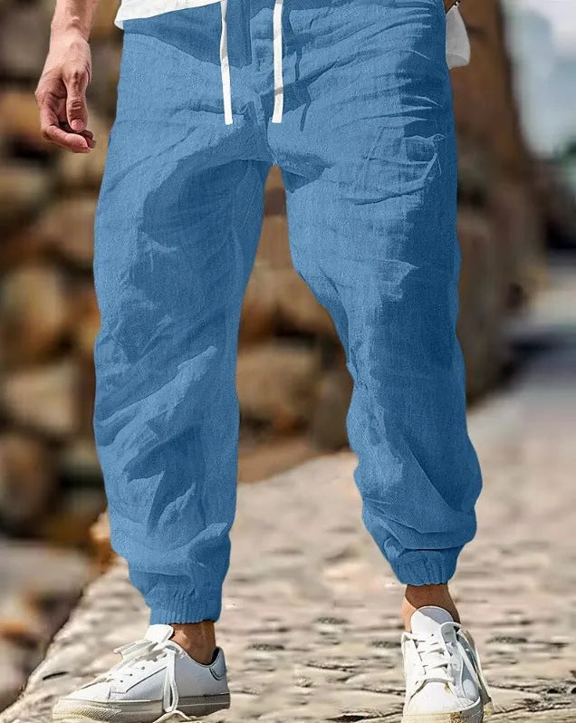Men's straight-leg cotton trousers in apricot colour with an elastic waistband.