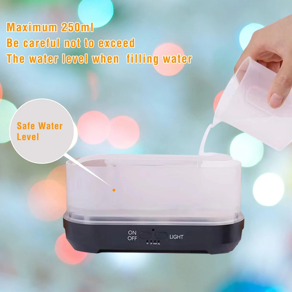 Christmas snowflake pattern humidifier with colourful flame effects and remote control on wooden desk
