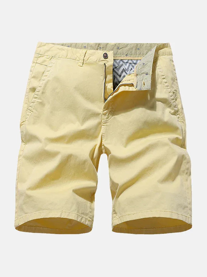 Man wearing loose-fit blue denim casual shorts with no belt, showcasing straight leg design.